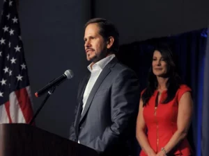 Knute Buehler gives a speech with Patty Buehler standing behind him